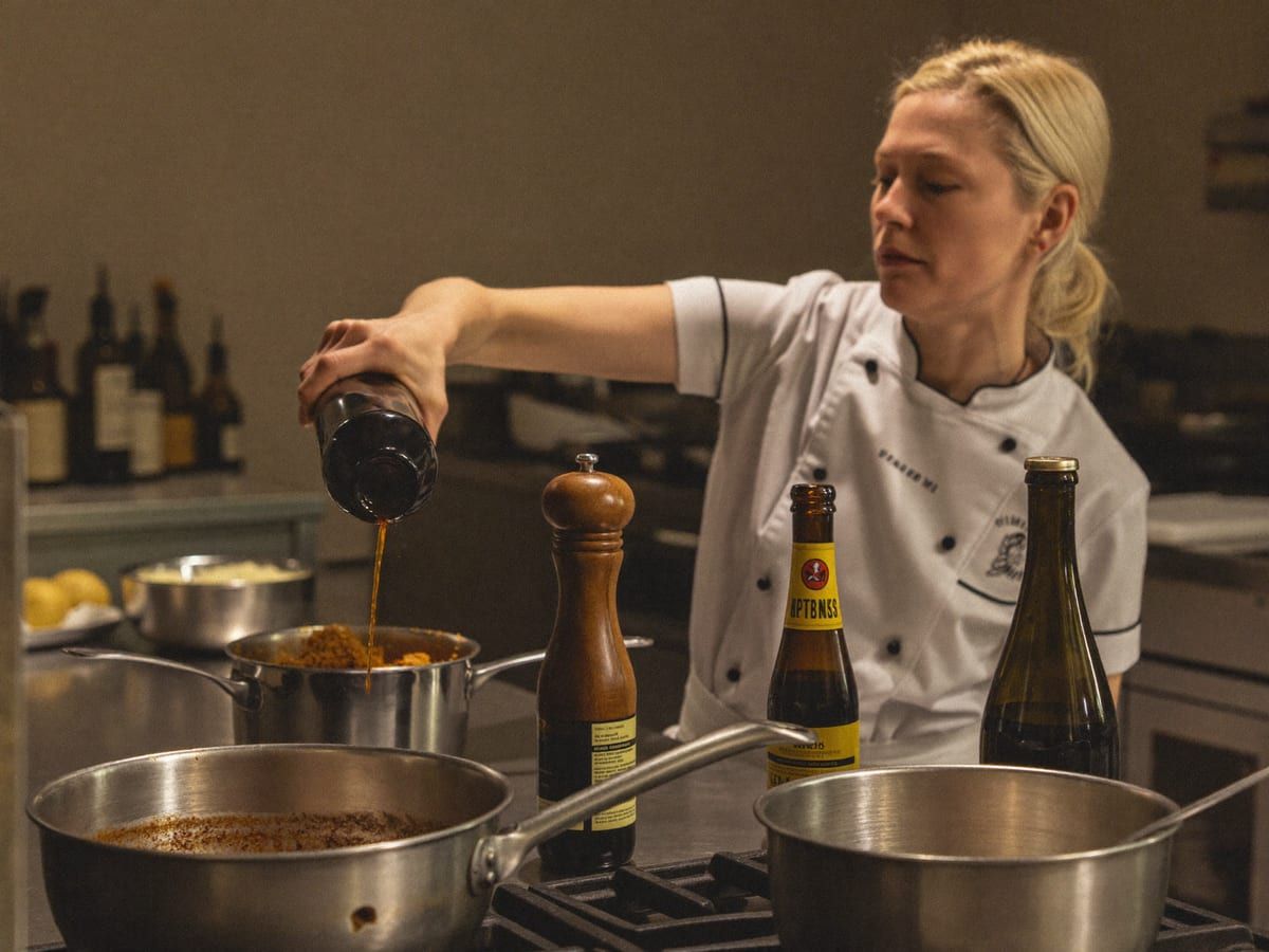 Chef finishing a sauce at the pass